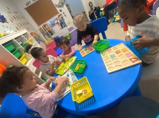 Children playing with puzzles and games at the table