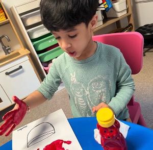 Child using glue during a craft activity